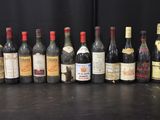 several bottles of wine are lined up on a table
