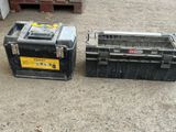 two black boxes sitting next to each other on the ground