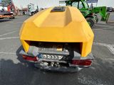 a yellow car that is parked in a parking lot