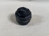 a black camera lens sitting on a white surface