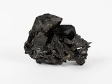 un gros plan d'un morceau de charbon noir sur une surface blanche