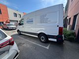 a white van parked in a parking lot next to a building