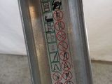 a person holding a metal object with a lot of stickers on it