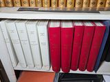 many books that are on a shelf in a bookcase