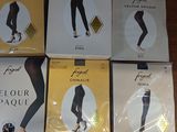 four pairs of leggings are sitting on a wooden table