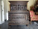 a very old wooden cabinet in the middle of a room