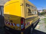 a yellow van that is parked next to a building