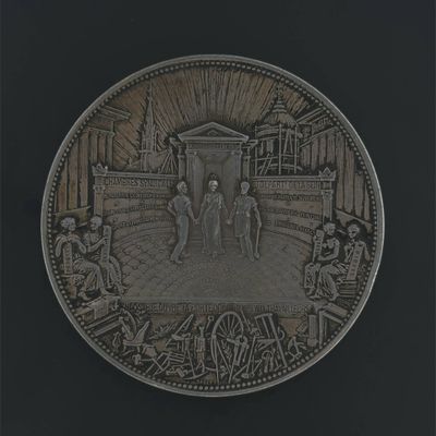 a silver coin with a picture of a man and a woman on it