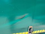 a close up of a green train with a yellow stripe