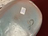 a small bowl with a sticker on it sitting on a table