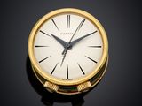 an image of a close up of a gold clock on a black surface
