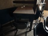a small table and chairs in a small room