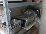 de nombreuses casseroles et poêles sur les étagères de la cuisine