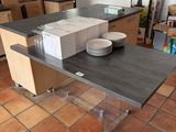 a kitchen with a table with a lot of plates and bowls on it