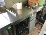 stainless steel counter top with a roll of toilet paper sitting on top of it