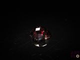 a close up of a red diamond on a black surface
