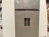 a refrigerator that is sitting in a warehouse with other appliances