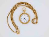 a gold pocket watch with a chain on a white surface