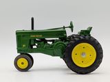 a toy tractor that is sitting on a white surface