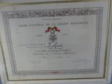 framed photograph of a certificate of the national legion dineur