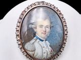 portrait of a young man in a white coat with a blue bow tie