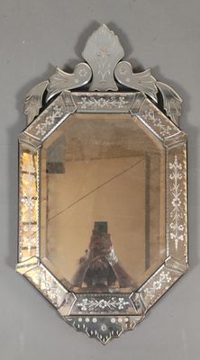 a mirror hanging on the wall with a person taking a picture
