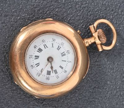 a gold pocket watch with roman numerals on it