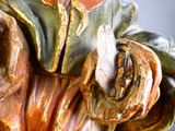 a statue of a man holding a flower in his hands