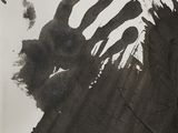 a black and white photo of a person ' s handprint
