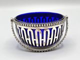 silver and blue glass bowl with the word ramaa on it