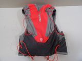 a red and grey backpack on a white surface
