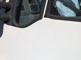 a white van parked in a parking lot with its door open