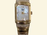 an image of a woman ' s wrist watch with a diamond set bezel