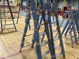 many ladders that are sitting on the floor in a building