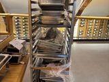 a stack of pans on a metal rack in a room
