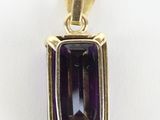 an image of a gold pendant with an amethorate stone