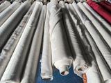 many rolls of fabric sitting on a blue surface