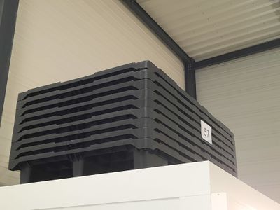 a black box sitting on top of a white refrigerator