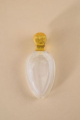 an image of a bottle of perfume on a white surface