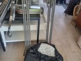 a black bag sitting on the floor next to a luggage bag