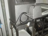 a machine that is sitting on a cart in a kitchen