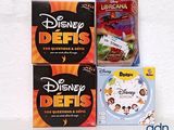 three disney defis board games sitting on top of a white table