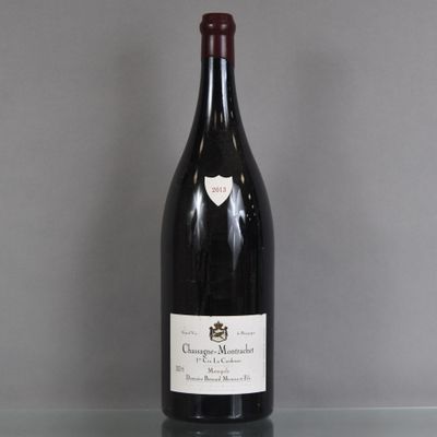 a bottle of wine sitting on a glass table