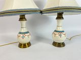 pair of white lamps with blue and gold trims on each of them