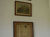 three framed pictures hanging on the wall above a toilet