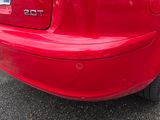 une voiture rouge garée dans un parking
