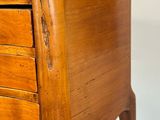 a wooden chest of drawers with a drawer underneath it