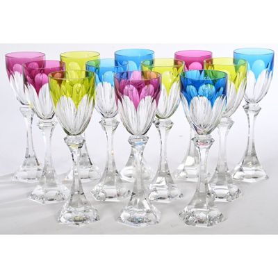 six colorful wine glasses are lined up in a row