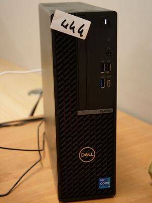 a dell desktop computer sitting on a desk with a sticker on it