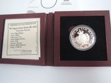 a picture of a silver coin in a wooden case